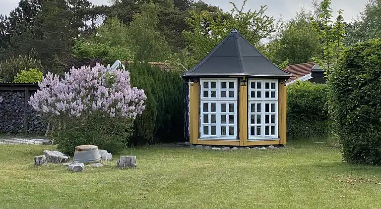 Lyst sommerhus tæt på havet i grønne omgivelser